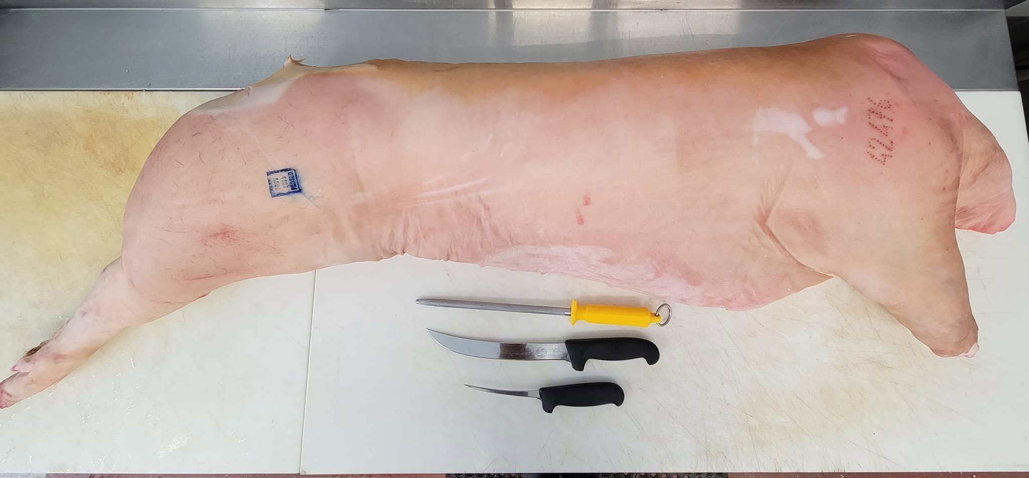 Bone-in pork leg with butcher knives